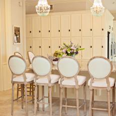 Traditional Neutral Kitchen With Bar Stool Seating And Chandeliers