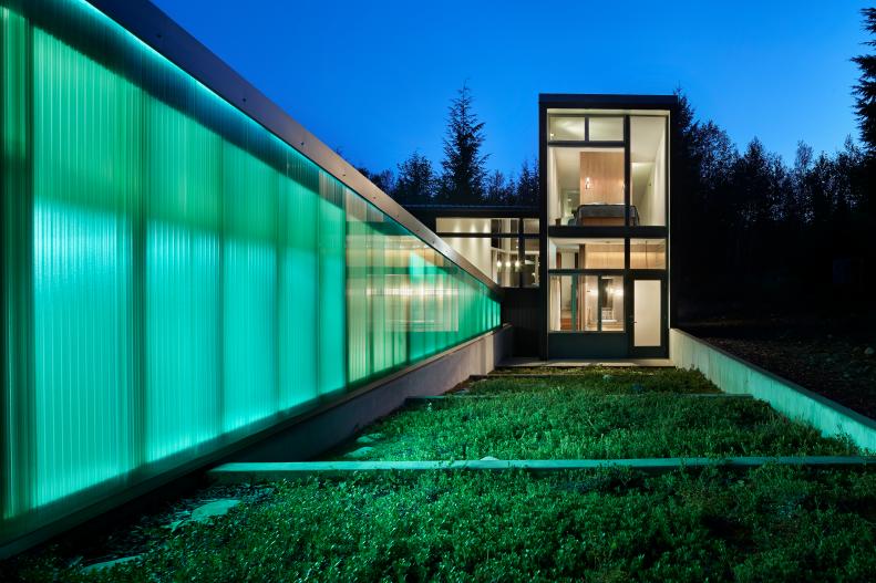 modern cabin with glowing walls at night