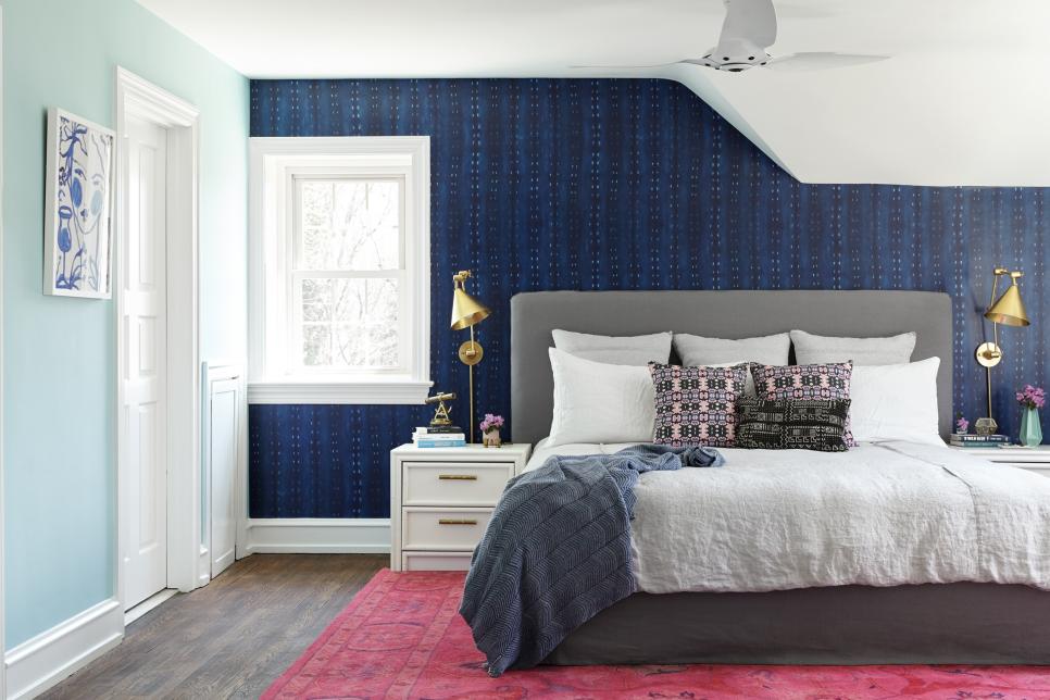 A bedroom with wall papers on the walls