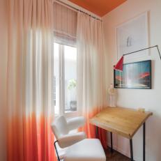 Modern Living Room With Orange Ceiling And Desk With Chair