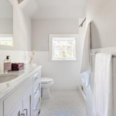 Gray Single-Vanity Bathroom With Purple Towel