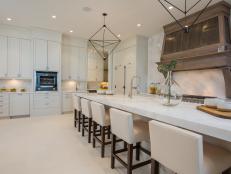 white kitchen with island and barstools