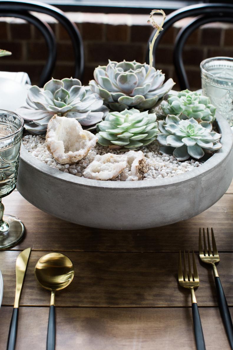 An oversized shallow container is the perfect vessel for a combination of echeveria cuttings and aquarium pebbles. “This piece can go formal or informal,” says Sara Fried of Fete Nashville. “The geode leans toward elegance while the concrete container is more farm table. I like the combination.”