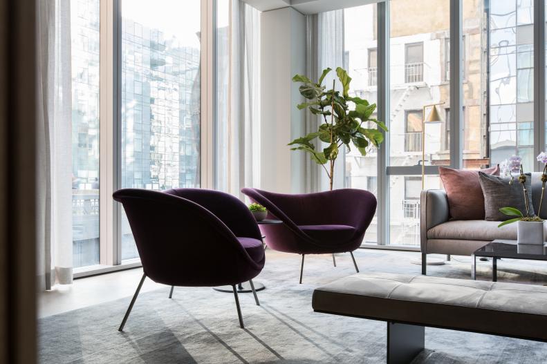 contemporary living room with purple armchairs