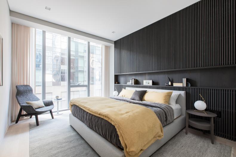 contemporary master bedroom with black accent wall