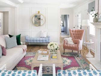 transitional living room with pink sofa