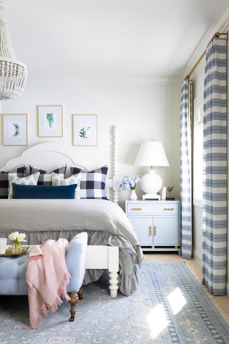 transitional master bedroom with plaid pilows