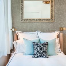 Metallic Mirror, Patterned Pillows Decorate Bed