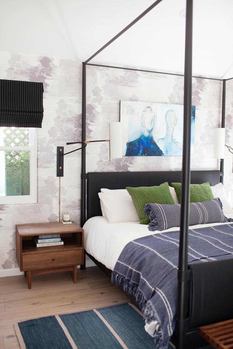 contemporary master bedroom with black canopy bed