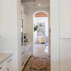 Bright White Butler's Pantry With Brass Hardware