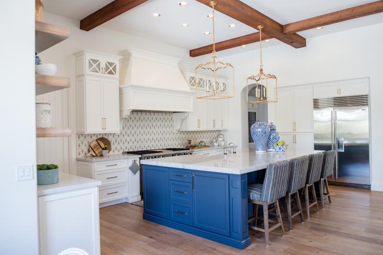 contemporary white kitchen with blue island