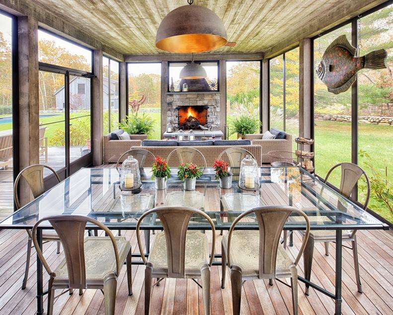 contemporary porch with dining set and fireplace