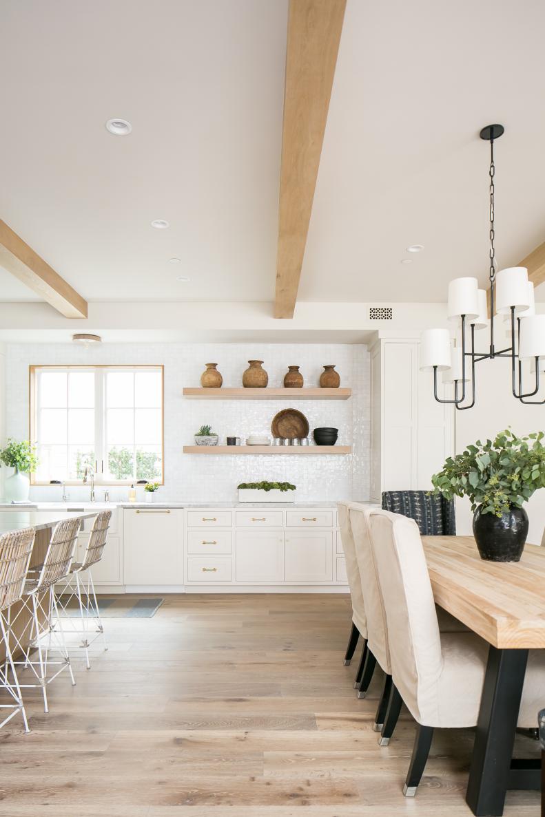 eclectic white kitchen with wood beams