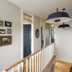 White Cottage Hallway Detail With Modern Blue Pendants And Natural Wood Trim