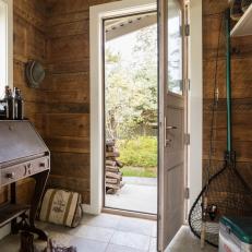 Rustic Cottage Mudroom With Wood Walls And Stone Tile Floor