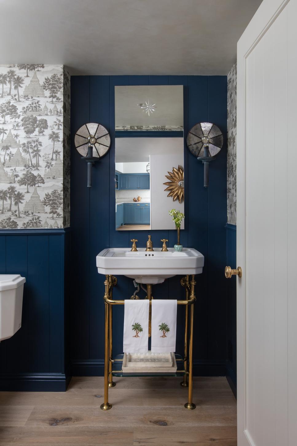 Hallway Door Opens to Dark Blue Powder Room | HGTV