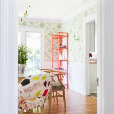 Eclectic Dining Room With Orange Shelving
