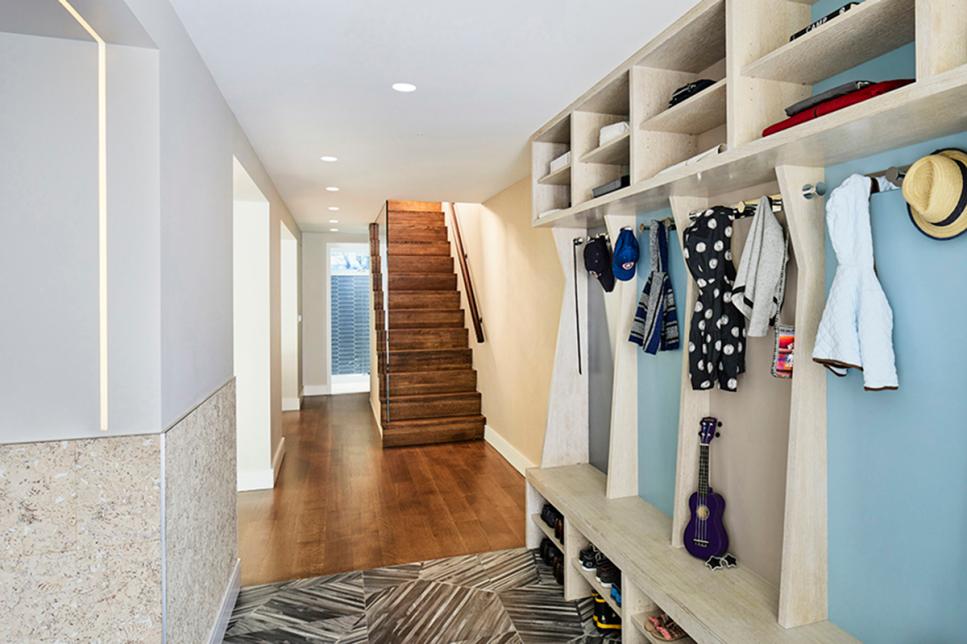 Mudroom Entryway With Color-Coded Cubby Storage and Wooden Stairs