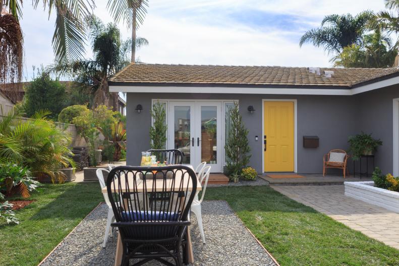 A pop of color is such a playful choice for a front door, and the warming yellow brightens the entire exterior.