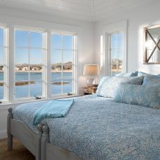 Blue and White Coastal Bedroom With Sailboat