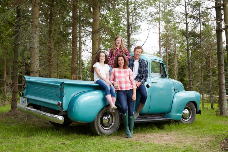 Publicity shot of,Sarah Richardson (middle) with Husband Alex Younger (right) with their 2 children, Robin (top midde) & Fiona (left) standing around pickup truck