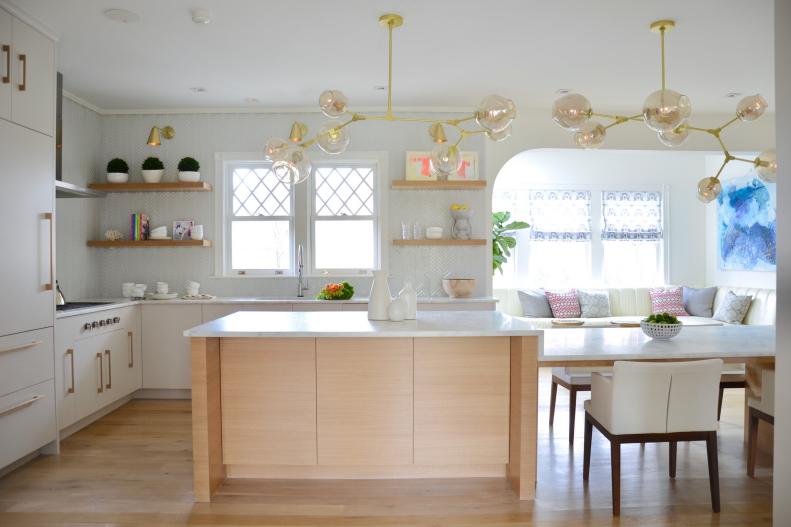 Modern Kitchen With White Cabinets And Gold Pendant Lights