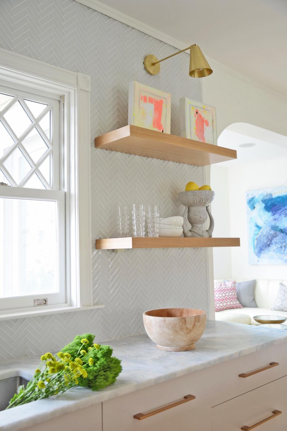 Modern White Kitchen Detail With Gold Wall Sconce And Floating Shelves With White Glass Tile Hgtv