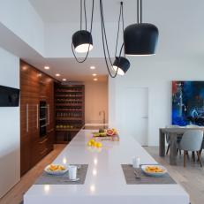 Modern Eat In Galley Kitchen With Work And Dining Island And Walnut Cabinets And Wine Storage
