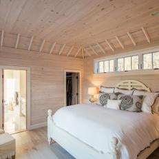 Modern Cottage Master Bedroom With Light Pine Paneled Walls And Ceiling