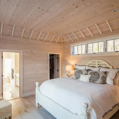 Modern Cottage Main Bedroom With Light Pine Paneled Walls And Ceiling