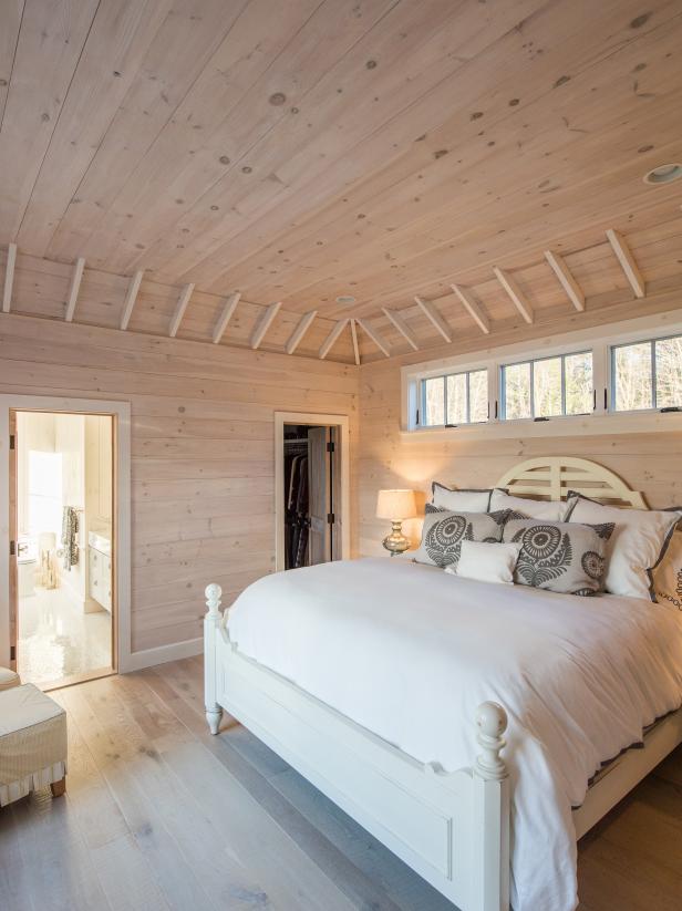 Modern Cottage Main Bedroom With Light Pine Paneled Walls And Ceiling