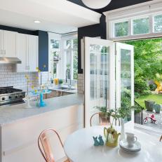 Blue and White Eat-In Kitchen With Backyard Access