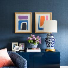 Dark Blue Sitting Room Includes Abstract Art, Bold Sideboard