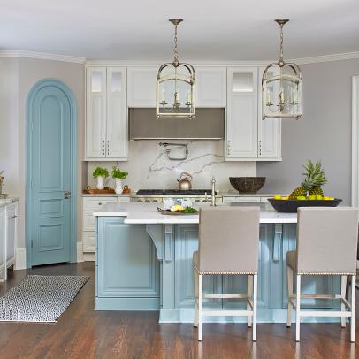 White Open Plan Kitchen With Blue Arched Door