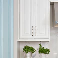 White Kitchen Cabinet and Two Pitchers