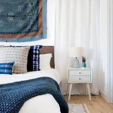 Contemporary White Master Bedroom With Blue Accents And Wood Headboard