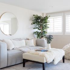Modern White Living Room With Gray Sofa And Faux Fur Accents