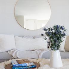 Contemporary Living Room Detail With White Upholstery And Accent Mirror