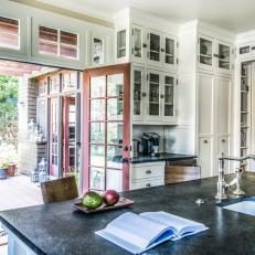 France Doors to Lawn from Craftsman-Style White Kitchen With Black Island Countertop