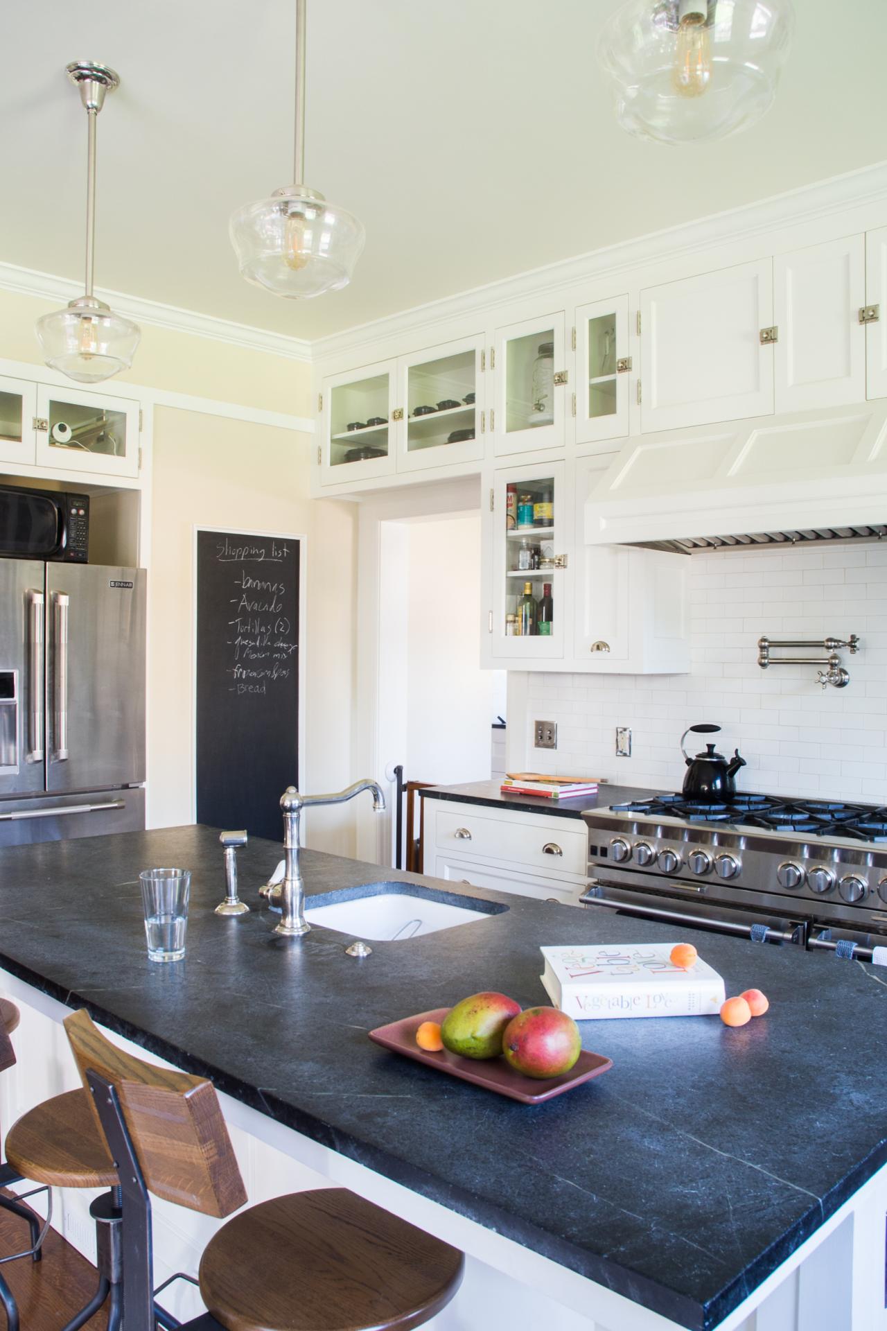 Black Slate Island Countertop And White Built In Cabinetry In