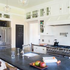 Black Slate Island Countertop and White Built In Cabinetry in Transitional Kitchen 