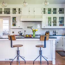 White Cabinetry in Craftsman-Influenced Kitchen with Large Island and Contemporary Barstools