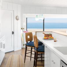 Modern White Beach House Kitchen With Retro Seating And White Counters