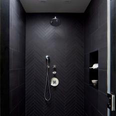 Modern Master Bathroom Shower Detail With Black Herringbone Patterned Tile And Skylight