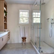 Modern White Bathroom With Glass Shower Enclosure And Marble Floors