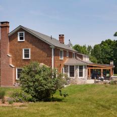 Contemporary New England Shingle Sided Home With Brick Chimney And Covered Patio