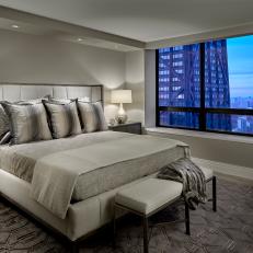 Modern Silver And Gray Master Bedroom With Upholstered Headboard and Contemporary Furnishings