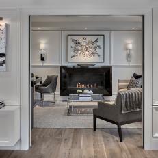 Modern White And Gray Sitting Room With Silver Art Deco Accents And Modern Black Fireplace