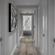 Contemporary White Hallway With Modern Art And Hardwood Floors