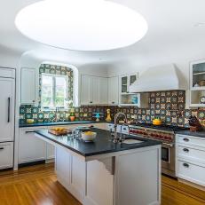 Contemporary White Kitchen With Spanish Tile Backsplash And Skylight